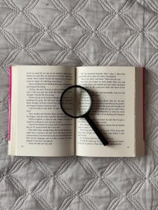 Magnifying glass positioned on an open book