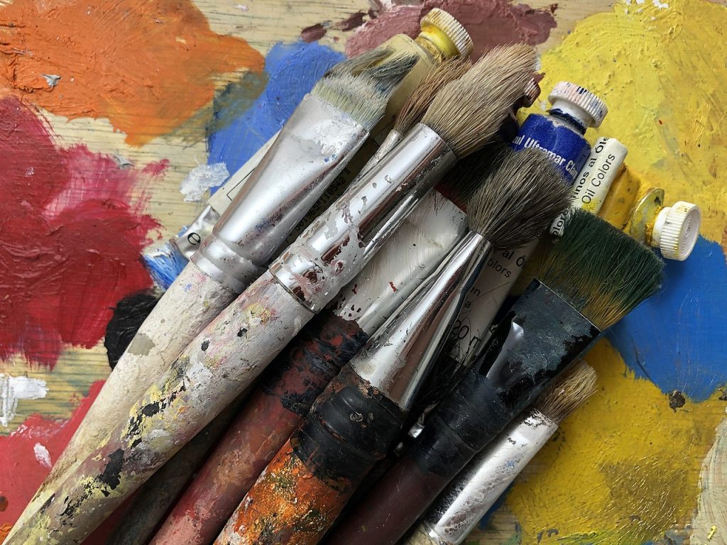 paint brushes and tubes of oil paints