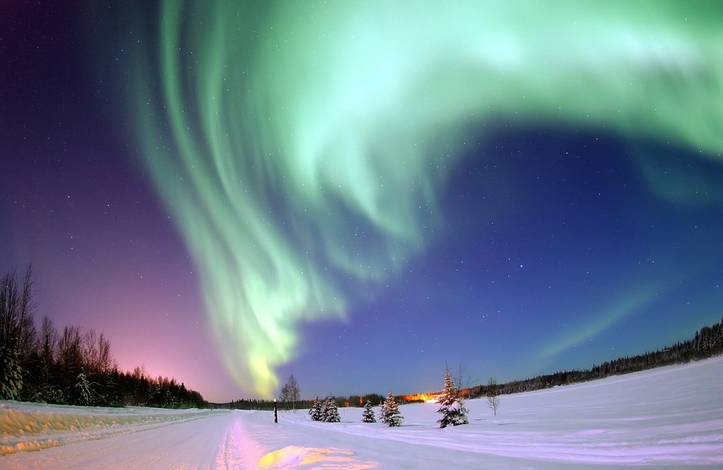 EIELSON AIR FORCE BASE, Alaska -- The Aurora Borealis, or Northern Lights, shines above Bear Lake here Jan. 18. The lights are the result of solar particles colliding with gases in Earth's atmosphere. Early indigenous groups believed different legends about the Northern Lights, such as they were the souls of animals dancing in the sky or the souls of fallen enemies trying to rise again.