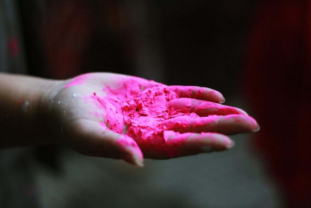 Hand holding pink powder