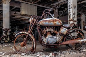 A bike with brown colour corroded material on it.